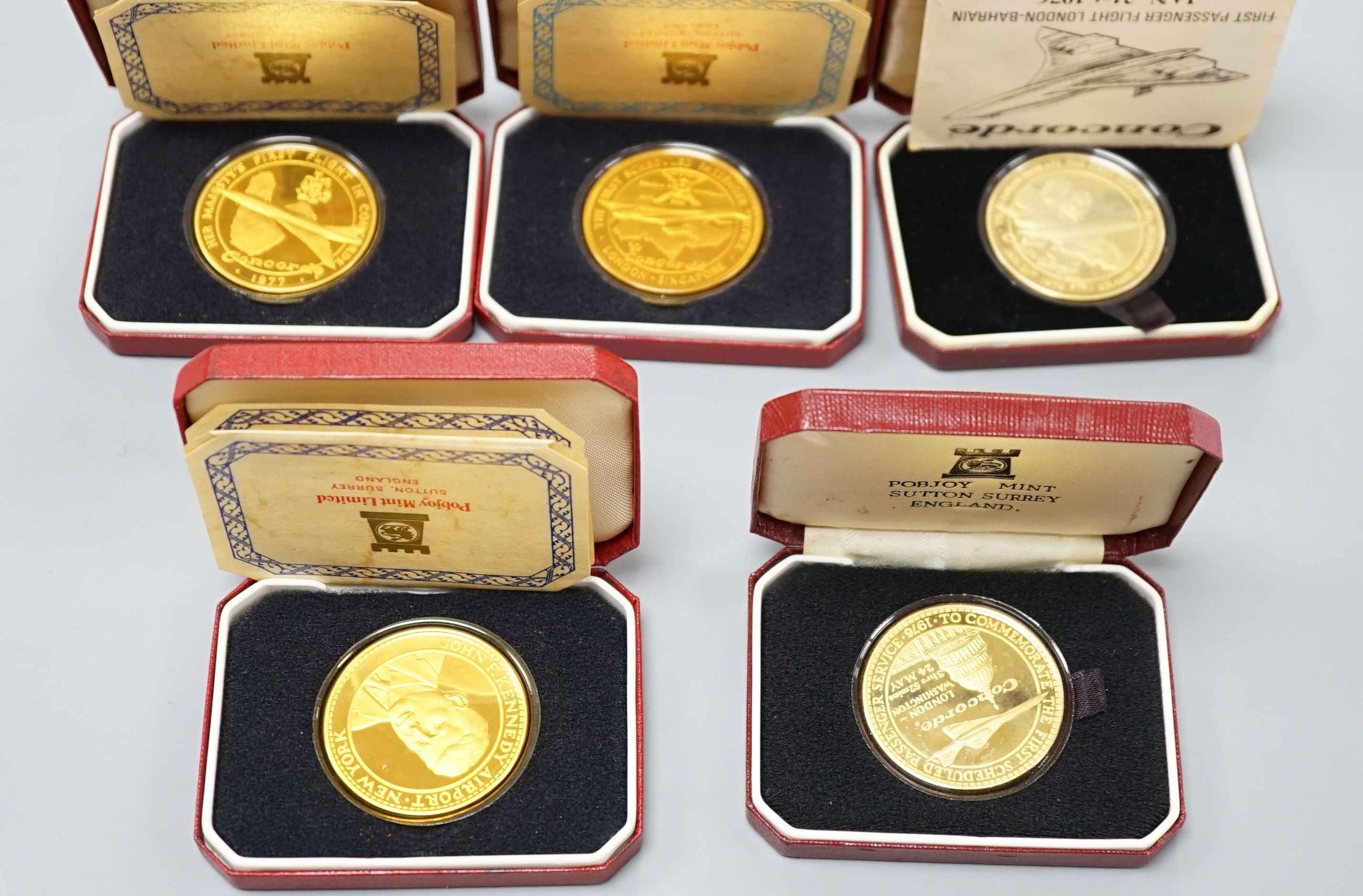 Five assorted cased Pobjoy Mint silver gilt Crown medals struck to commemorate first flights of Concorde, with certificates